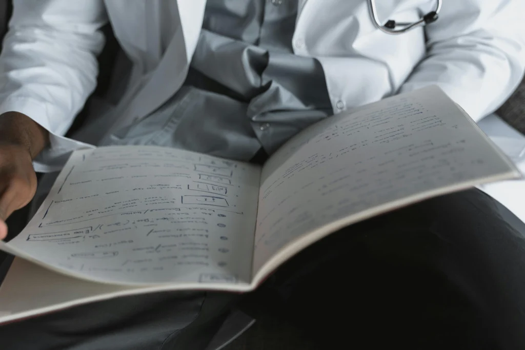 Person in labcoat Reading Book